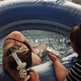 woman in birth pool using entonox supported by independent midwife debbie hemmingway